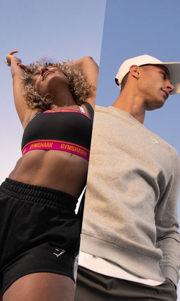 Female wearing the Strike Sports Bra in black, male wearing the Arrival t-shirt in grey. 